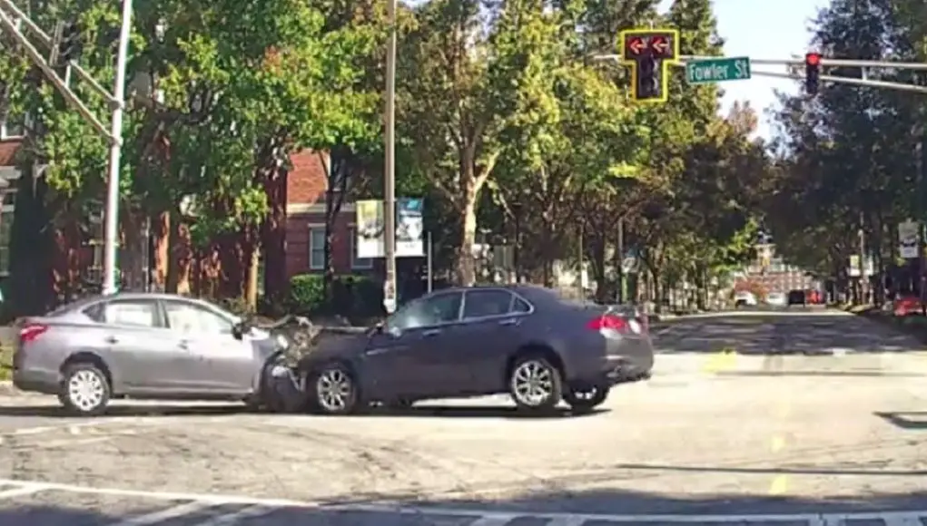 Two drivers in Atlanta GA near Georgia Tech try to beat a red, end up crashing into each other.