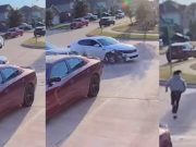 A Kia Optima sedan stolen by three african american teens is seen hitting a parked car with one of the suspects running.