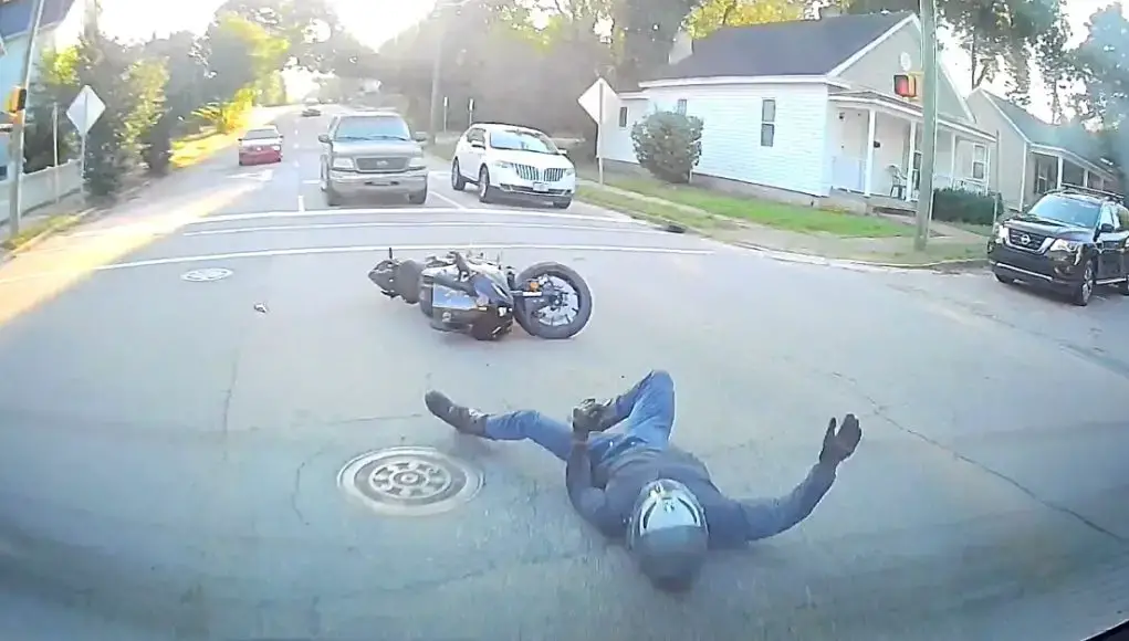 Motorcyclist on his brand new bike on E Edenton St slams into dashcam owner.