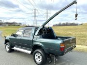 A 1995 Toyota Hilux with factory mounted crane.