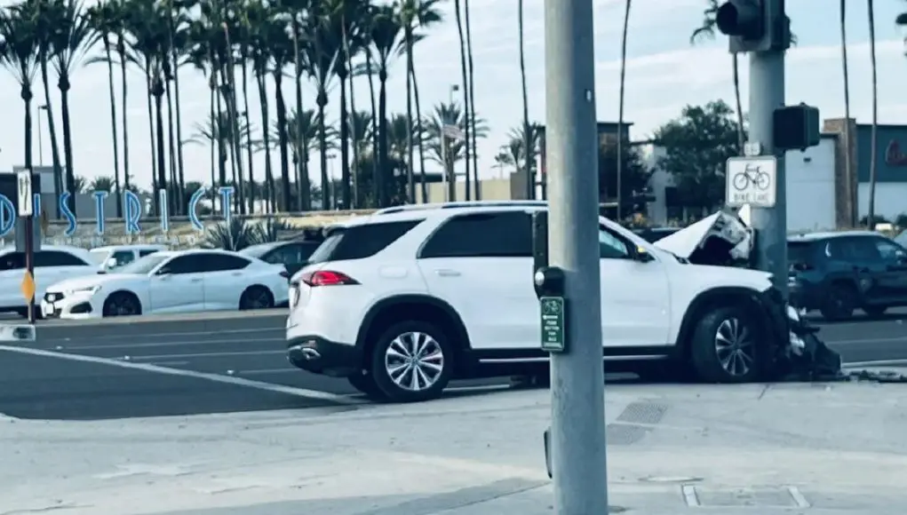 Woman driver in Irvine undeersteers out of control into a traffic light pole.