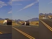 A driver makes an illegal u-turn across a gore point, almost colliding with a dump truck.