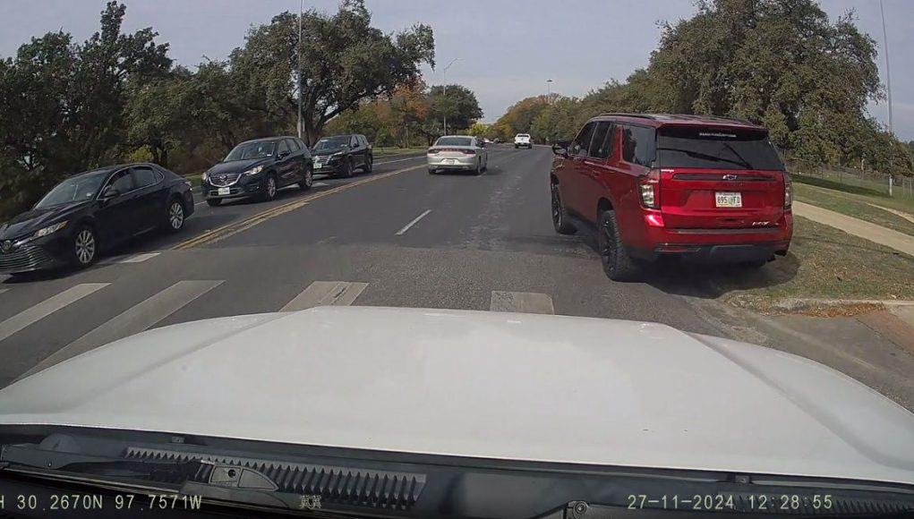 Unhinged driver hoping onto W Cesar Chavez St. sidewalk in Austin.