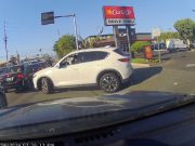 Standoff between shoulder user and Mazda in driveway poking his way out.