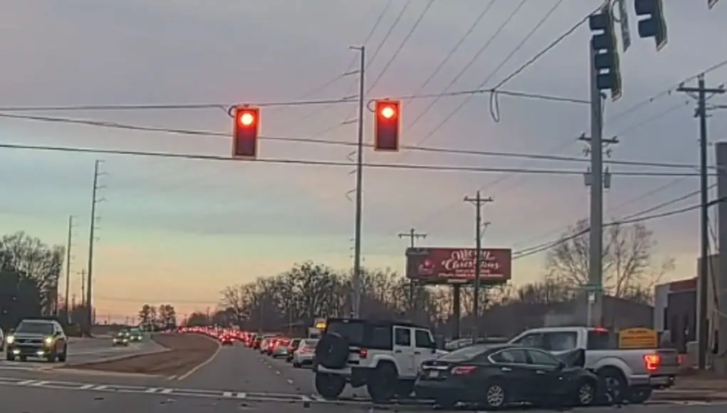 Reckless driver in Altima in Cumming, GA runs a red light at GA-141 and Majors Rd and collides with a left turner who also failed to yield.