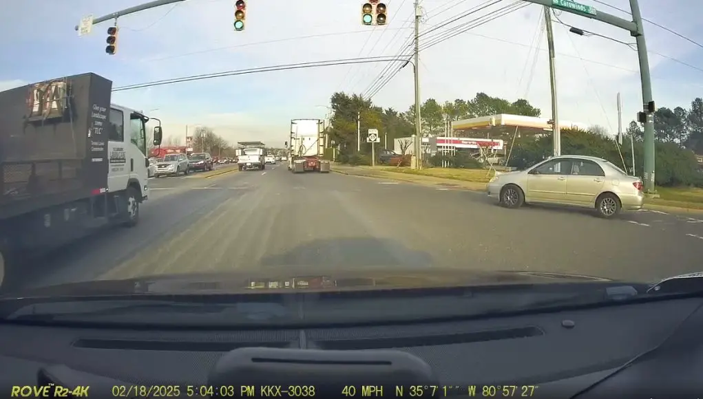 Idiot in Charlotte fails to stop and yield for traffic on right on red on Caroway and Tyron. Almost collides with dashcam owner.