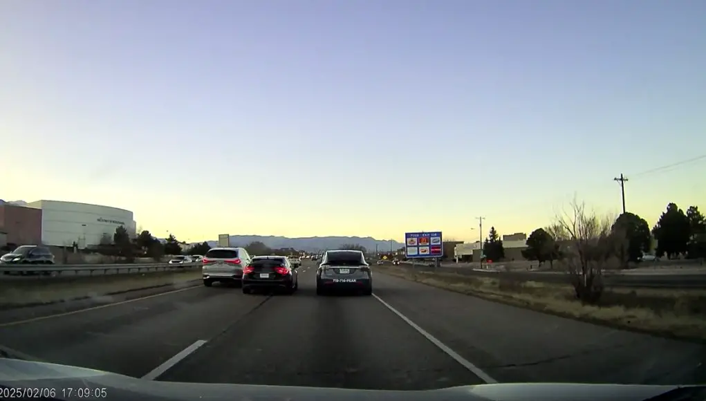 Lane splitter Colorado Springs Dashcam captures driver on I-25 in Colorado Springs dangerously lane splitting between two vehicles in his Honda Civic.