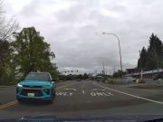 Idiot driver makes illegal left turn on E Main Ave across doube yellow lines and against traffic.