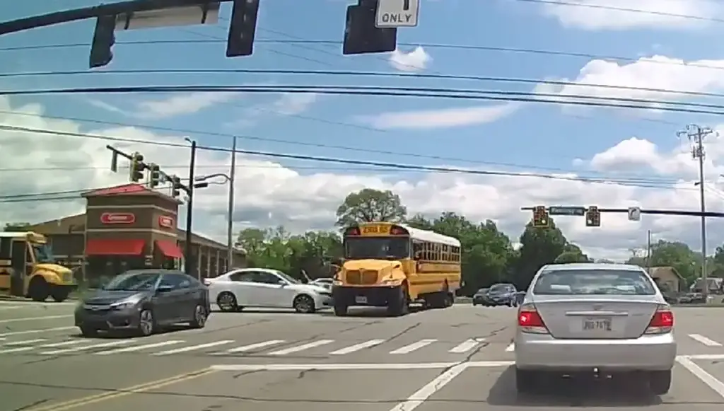 Idiot and possibly distracted driver blows through red, t-bones school bus on Reading and Snider.