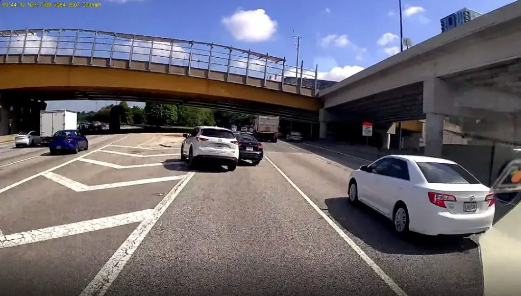 Idiot driver brute forces a multi-lane lane change across gore point only to cause an accident.
