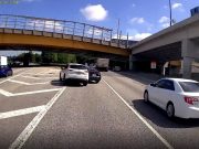 Idiot driver brute forces a multi-lane lane change across gore point only to cause an accident.