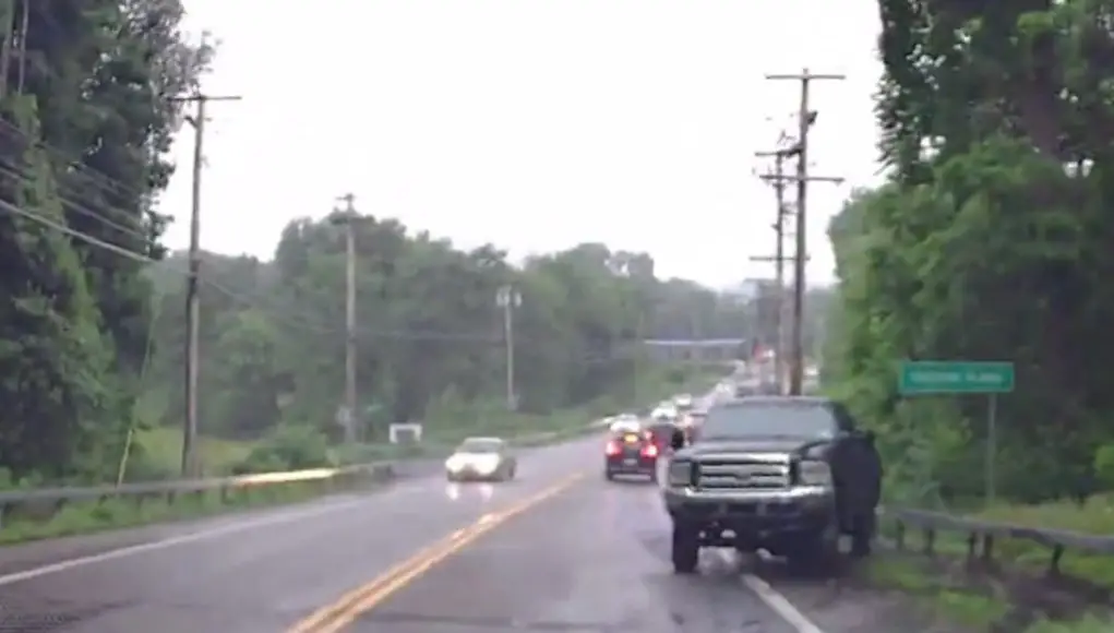 Lifted truck with bald tires on the 55 in Poughkeepsie loses control on rain-soaked road, crashes into guardrail.