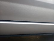 What looks like orange peel like texture on the lower half of the door of a Toyota Corolla.