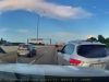 Driver on 410 exit makes unsafe lane change between two vehicles, almost causing a multi-vehicle collision.
