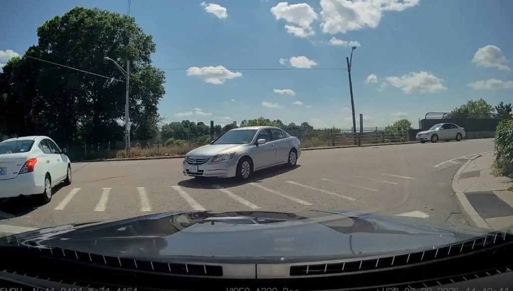 Distracted driver turns into a wrong way turner onto River St.
