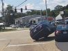 Careless driver attempts right turn from straight only lane. Causes accident, runs over the hood of car turning from the right lane.