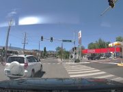 Ignorant driver on E 9th St. and Virginia pleads ignorance, does illegal lane change in the middle of the intersection.
