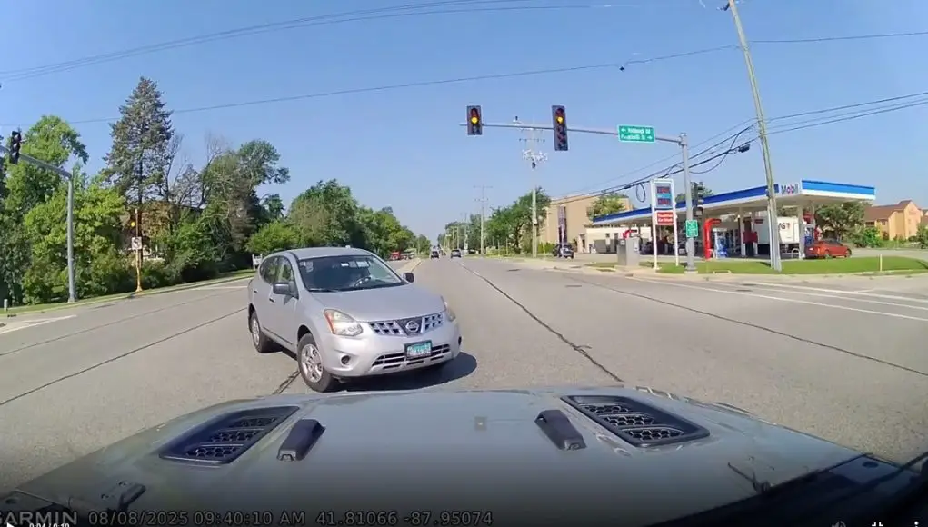 Clueless driver on Ogden Ave makes left turn against red light in front of dashcam owner. Come within inches of colliding.