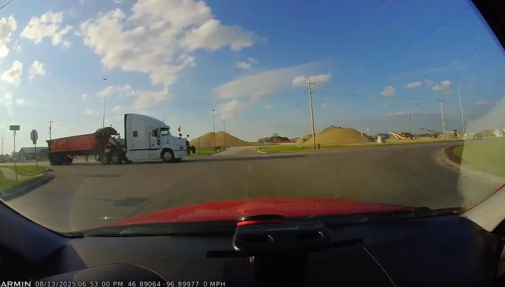 Semi truck driver in West Fargo at ND-294 and 12th Ave NW blows through stop sign without slowing.