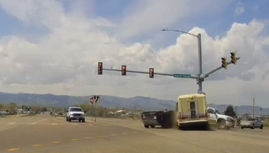 Shuttle bus driver on Mulberry in Ft. Collins blows red light, t-bones turner towing a utility trailer.
