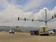Shuttle bus driver on Mulberry in Ft. Collins blows red light, t-bones turner towing a utility trailer.