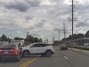 Driver turning left across stopped traffic fails to yield, gets hit by driver possibly illegally cruising down two-way-left-turn lane.