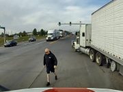 Road raging semi truck driver in the wrong dangerously passes fellow semi driver to confront them despite being in the wrong.