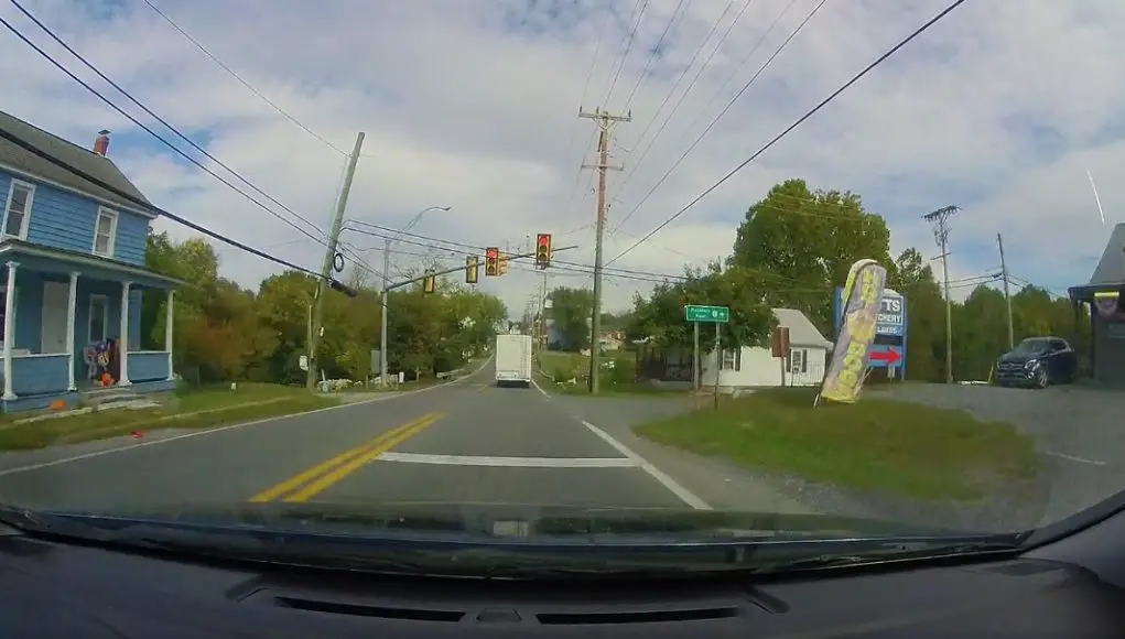 Camper Van nearly runs red light at US-11 and Hatchery Rd. setting up dash cam owner for potential accident, but saved by safe following distance.