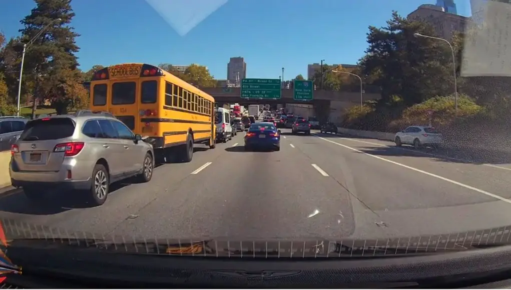 Distracted driver rear ends school bus on the Vine Street Expressway/95 causing thousands in damage to at least one vehicle.