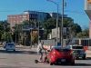 Brain-dead College scooter rider blasts through busy intersection against no-crossing signal. Gets clipped by innocent driver sending him to the concrete.