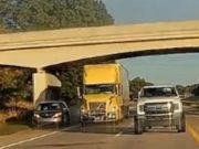 Minivan driver dangerously uses emergency shoulder to pass fully loaded semis.