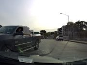 Ram Pickup driver on 20th Ave tries to cut traffic by going the wrong way. Stopped by dashcam owner who refuses to budge.