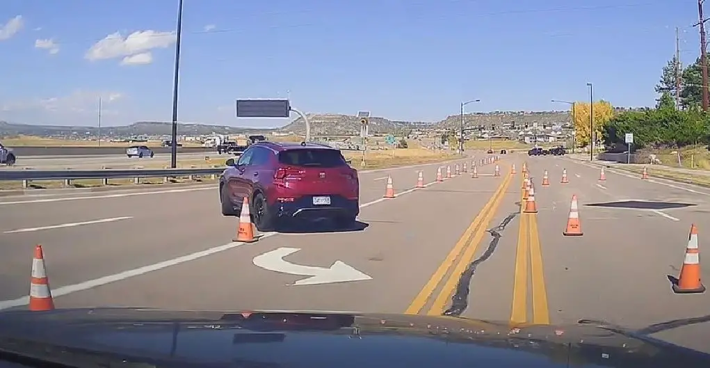 Elderly lady driver gets confused by cones rerouting traffic on Front St. Drives into oncoming traffic as a result.