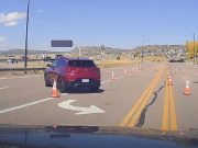 Elderly lady driver gets confused by cones rerouting traffic on Front St. Drives into oncoming traffic as a result.