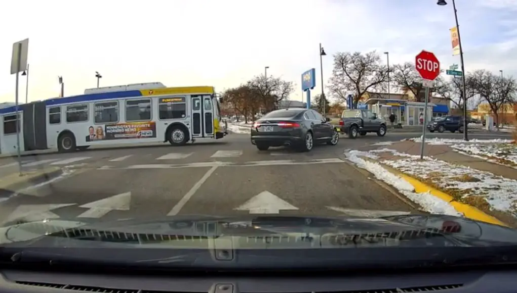 A careless, stop sign running Metro Transit driver nearly rear ends driver in truck legally towing a car.