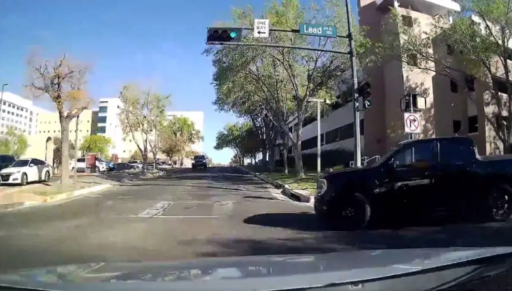 Red light runner on lead and cedar fails to yield before turning, almost collides with dashcam owner.