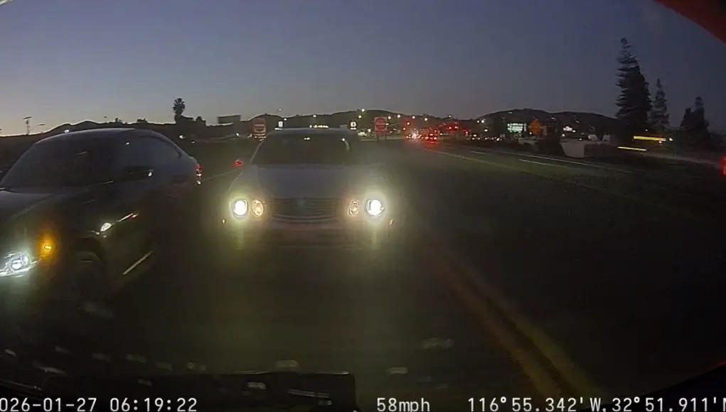 Mercedes driver refuses to let BMW driver merge in front of him on CA-67 merge point. BMW almost crashes into road sign.