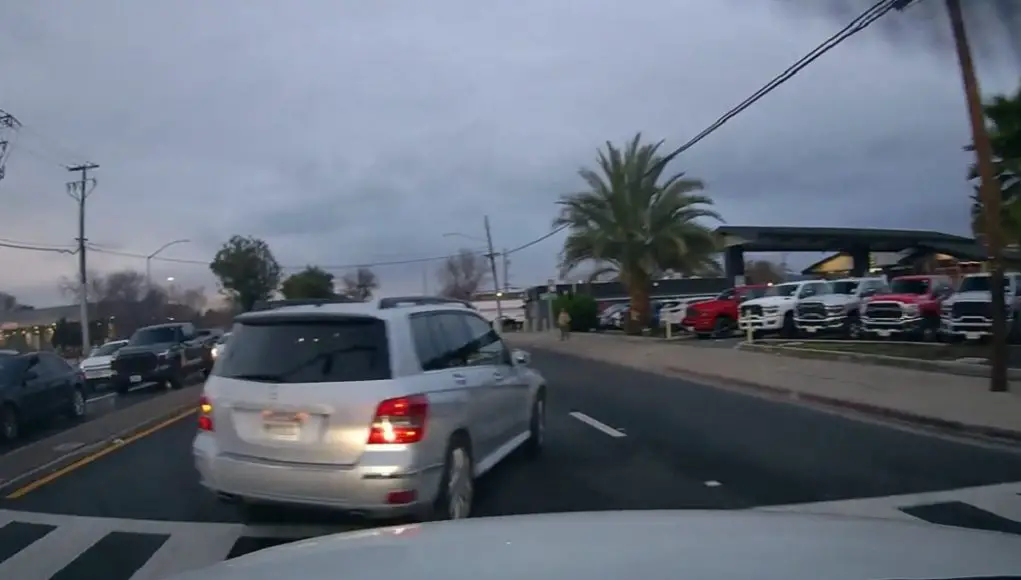 Unsafe driver in Mercedes on Detroit and Monument ignores turn lane markings, almost causes massive collision with dashcam owner.