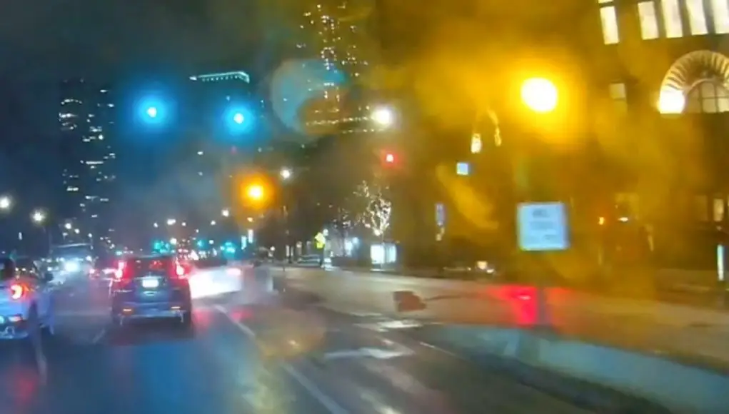 Tesla on Lake Shore tries to pass in right turn only lane, ends up crashing into traffic light concrete foundation base instead.