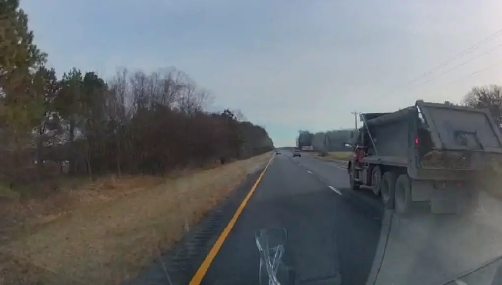 Dump Truck driver on Ocean Gateway loses part of its load, a 100+ pound Hay Bale comes toppling out.