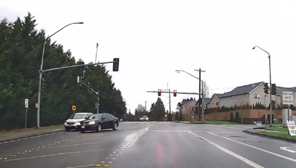 Distracted driver runs red at Seattle Hill and 148th setting himself up for a collision course with turner with the right-of-way.