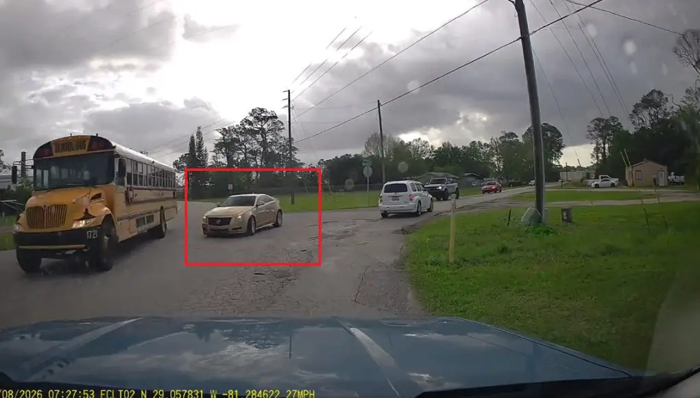 Careless driver doesn't look, blindly turns onto Biscayne Blvd, narrowly avoids hitting bright yellow, Volusia District School Bus.