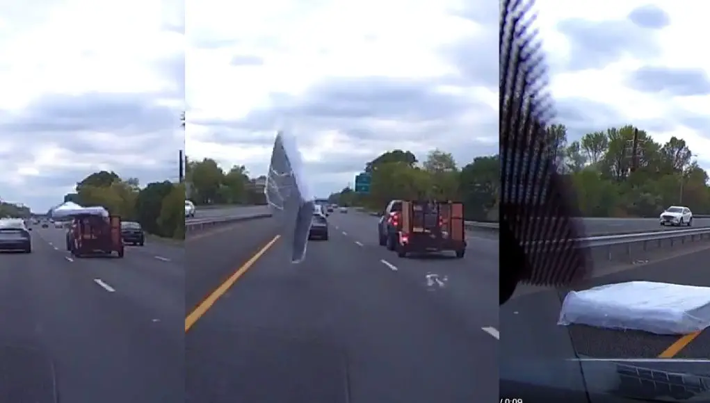 Unsecured mattress comes flying out of utility trailer onto I-295, barely missing dashcam owner's car.