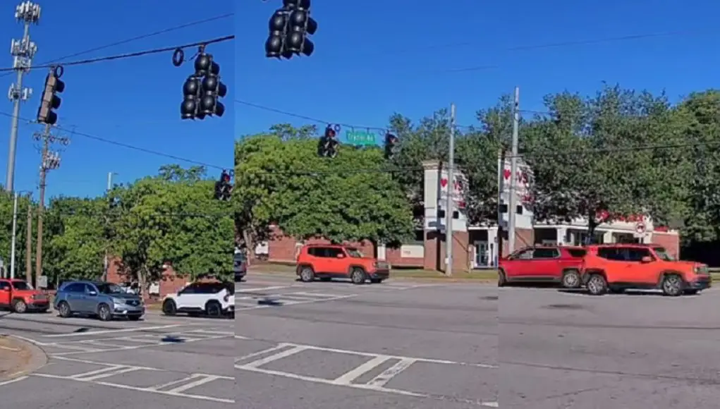 Jeep driver frustrated that driver in front of them is not moving, risks accident running red light instead.