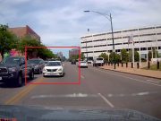 Driver on S Ogden Ave W tries to head the wrong way against traffic, across double solid yellows to cut traffic. Forced back in.