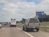 Goofball on I-35 uses the emergency shoulder to pass despite the fast lane being wide open.