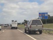 Goofball on I-35 uses the emergency shoulder to pass despite the fast lane being wide open.