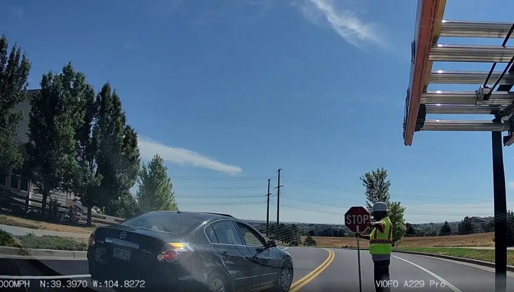 Castle Rock, CO: Altima Driver On Crimson Sky Dr Tries to Bypass Street-Painting Traffic by Crossing Double Yellow—Flagger Sends Them Right Back Altima driver too good too wait tries to by pass stopped traffic on Crimson Sky Dr. Stopped by a dedicated flagger.
