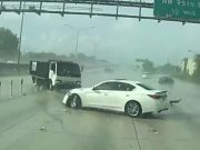 Infiniti driver caught speeding on rain-soaked I-95 loses control and crashes into truck, totalling his ride, too.