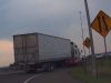 Goofball tries to pass semi on I-70 on-ramp using emergency shoulder. Gets side mirror ripped.